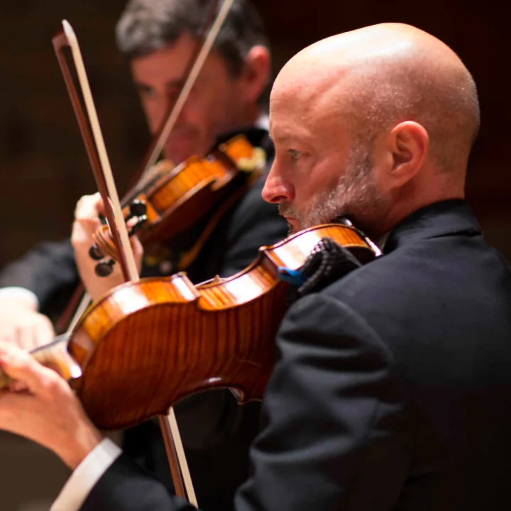 Erik Chapman playing the violin in the Orchestra