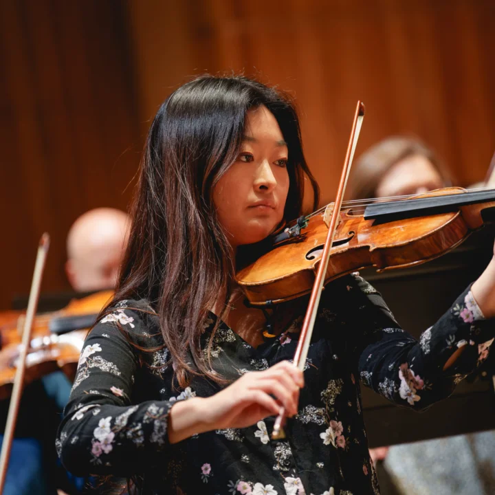 Esther Kim playing the violin in the Orchestra
