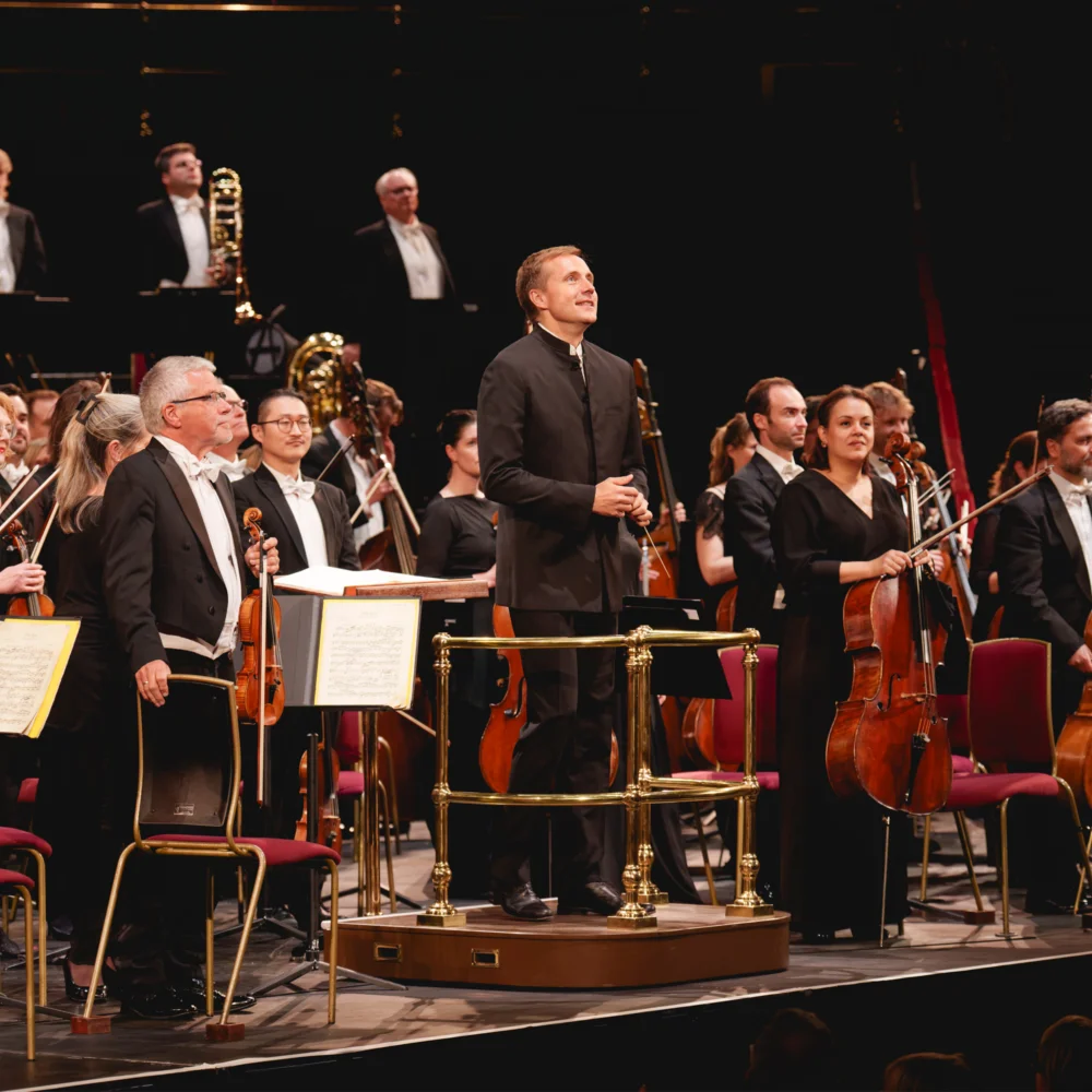 Vasily Petrenko and the RPO standing for applause on the stage of the Royal Albert Hall