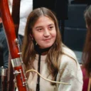 An RPO bassoonist in rehearsal smiling and looking at another player