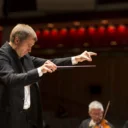 Vasily Petrenko conducts the orchestra at the Royal Festival Hall, he is pointing.