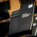 An RPO-branded folder on a music stand