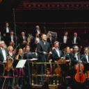 Vasily Petrenko and the RPO standing for applause on stage at the Royal Albert Hall