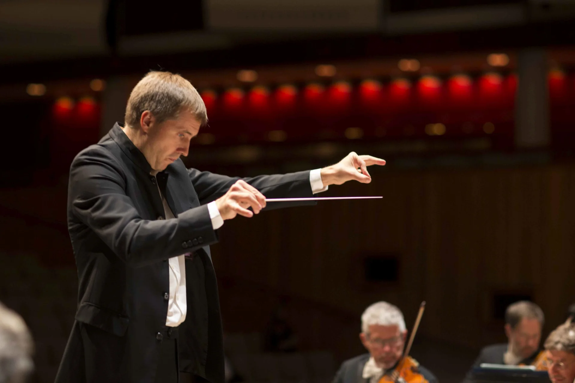 Vasily Petrenko conducts the orchestra at the Royal Festival Hall, he is pointing.