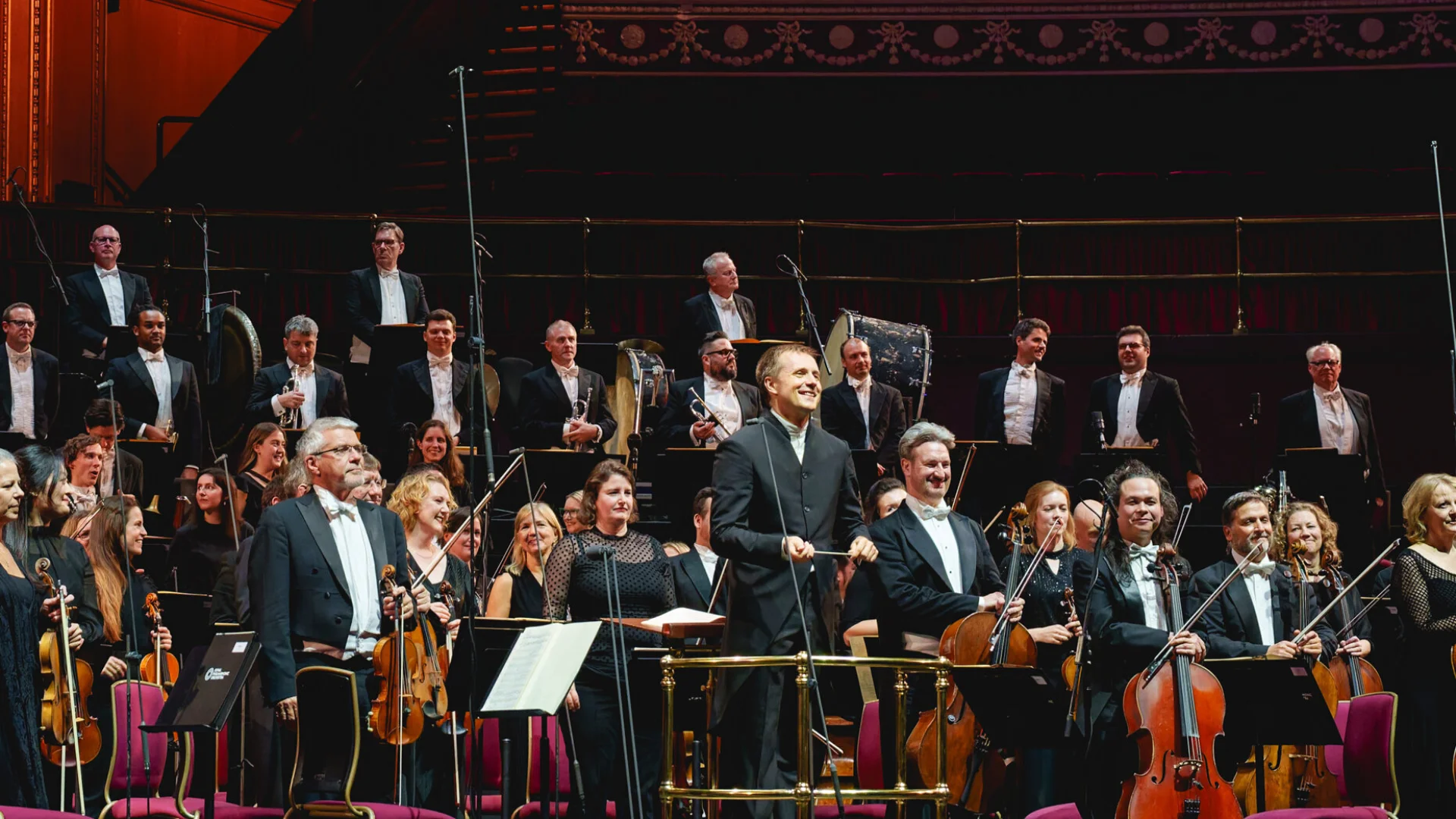 Vasily Petrenko and the RPO standing for applause on stage at the Royal Albert Hall
