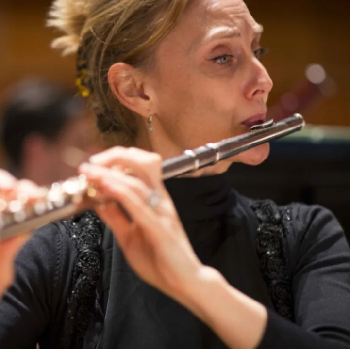 An RPO flautist playing in concert dress