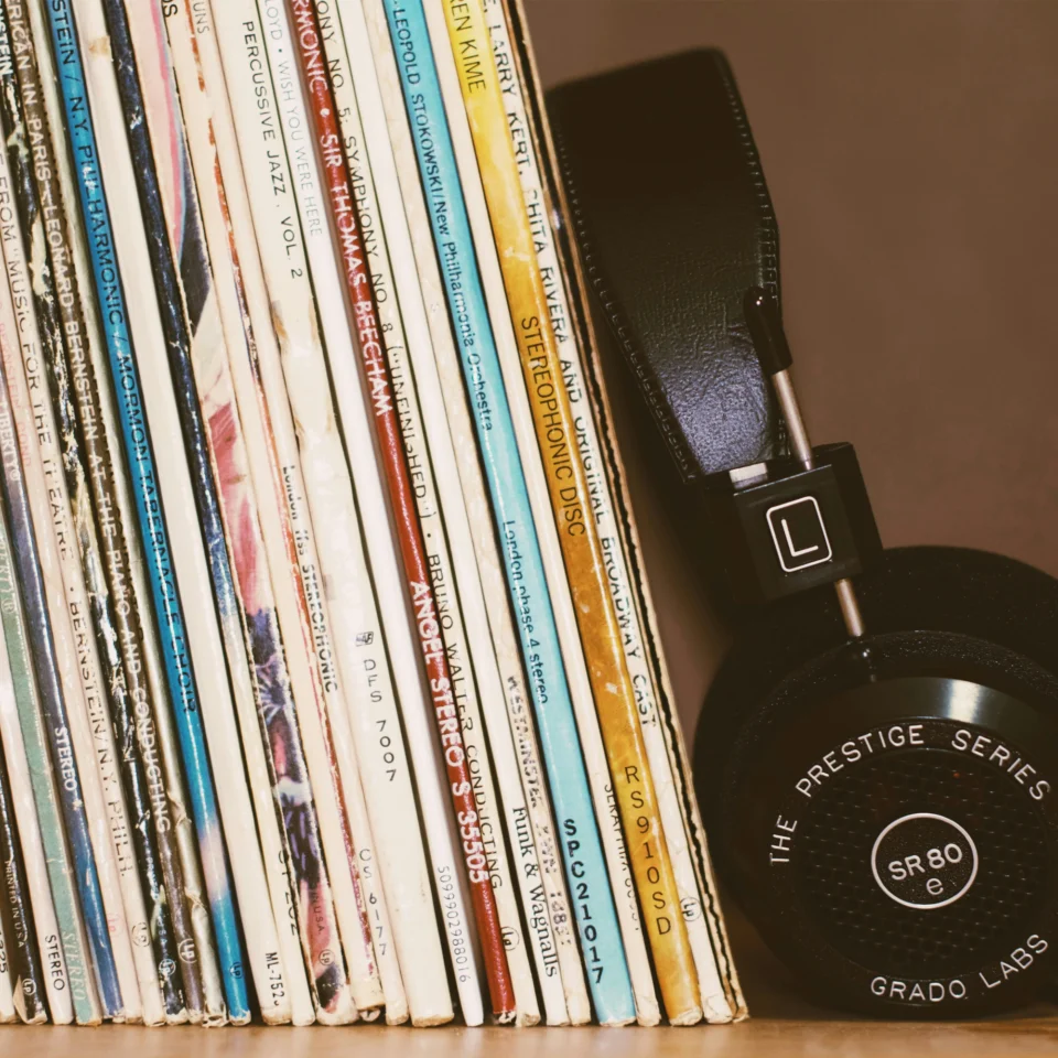 A row of classical vinyls with headphones leaning against them