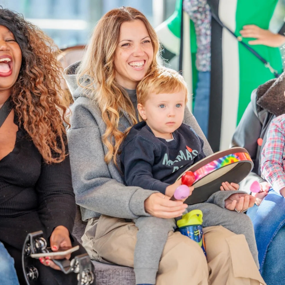 Smiling parents and children watching a Relaxed Performance