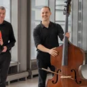 A double bassist smiling in an Relaxed Performance breakout session