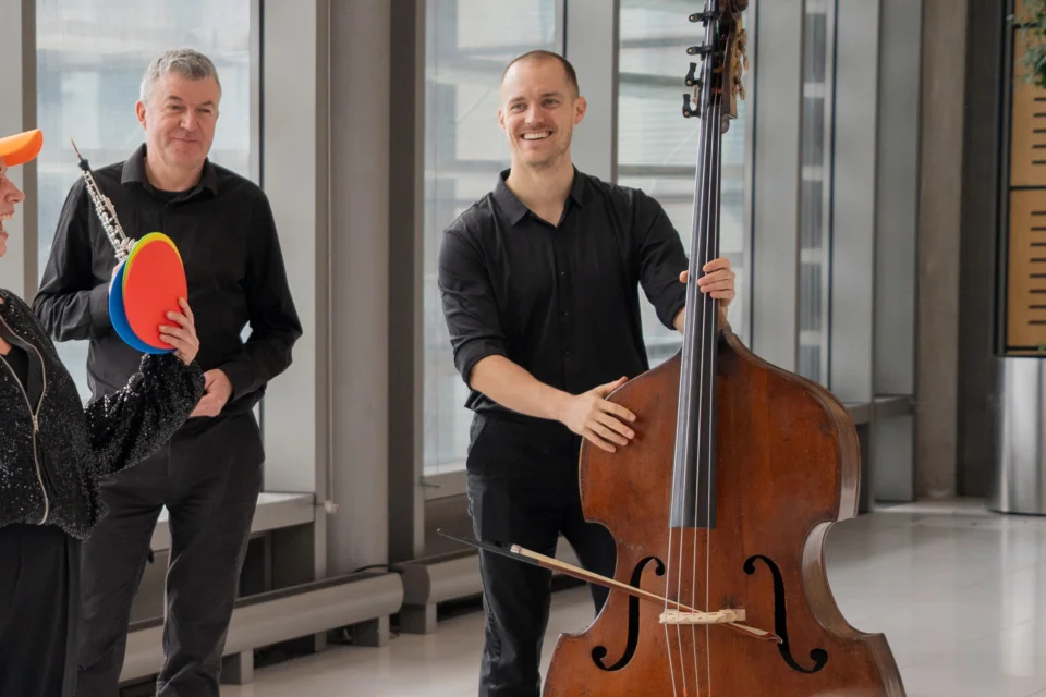 A double bassist smiling in an Relaxed Performance breakout session