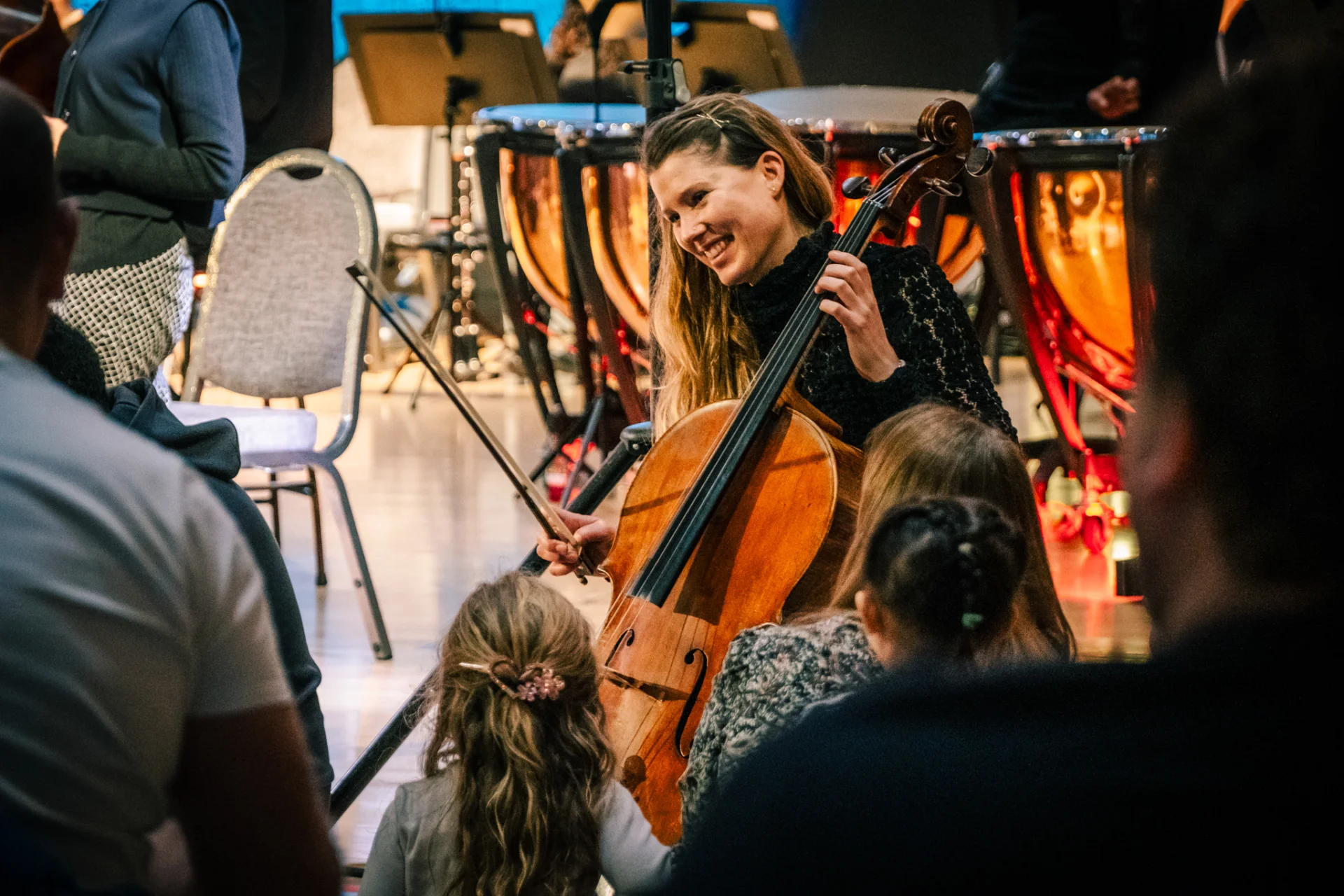 A cellist performs for children at a Relaxed Performance