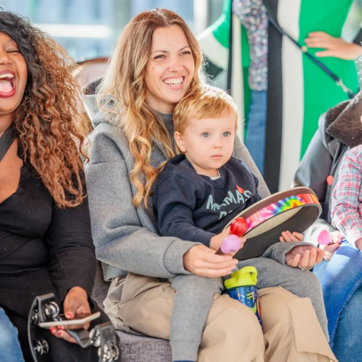 Smiling parents and children watching a Relaxed Performance
