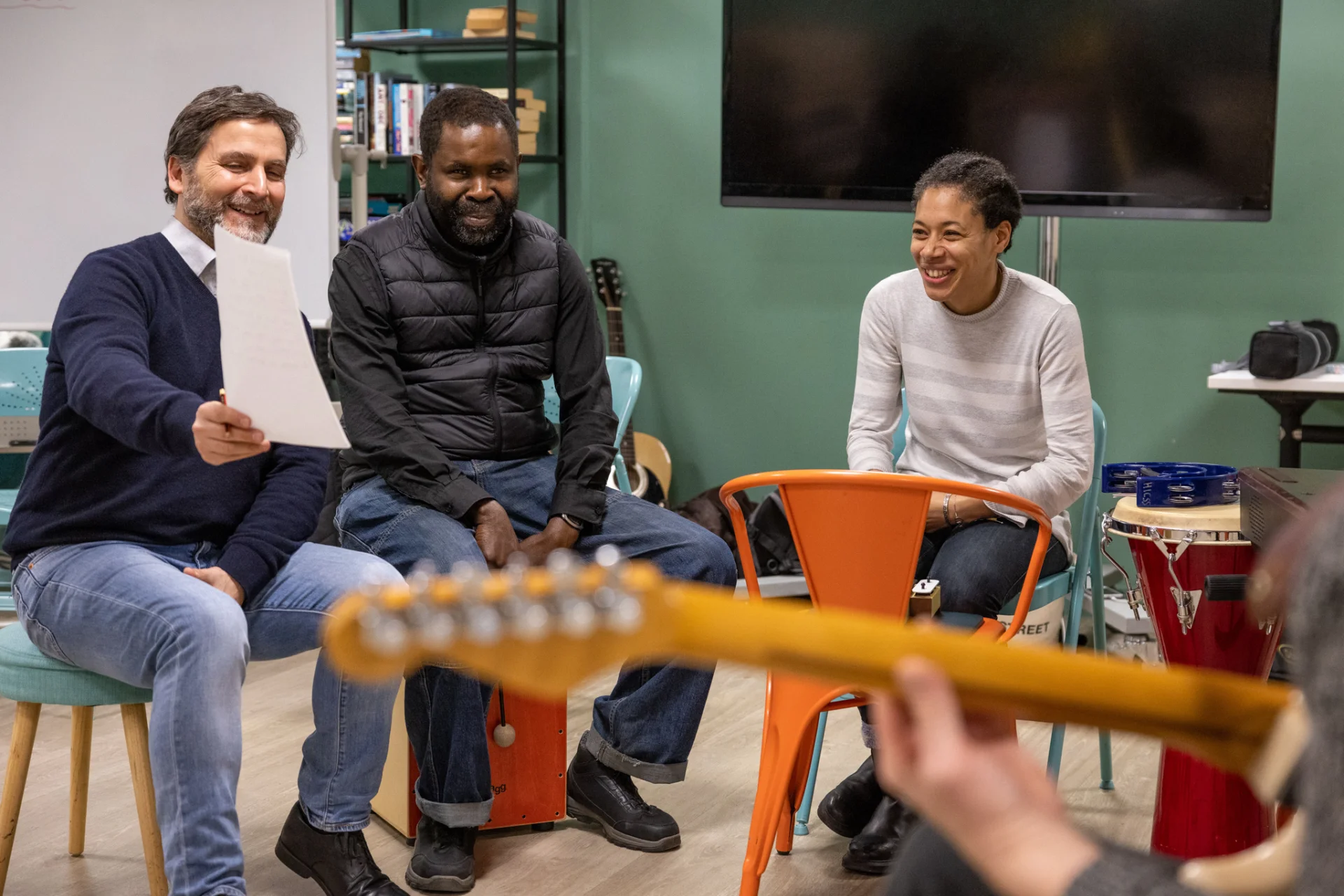 Sound Sanctuary participants smiling during in group discussion.