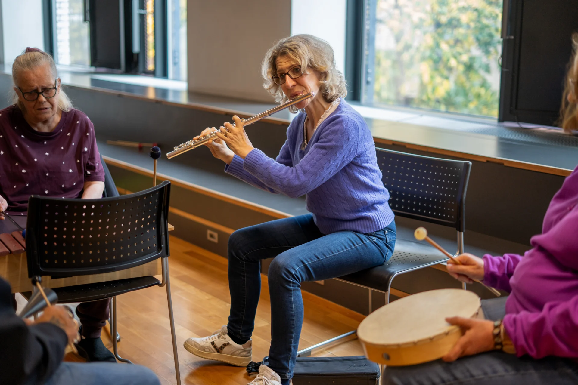 Flautist Joanna Marsh playing with Sound Sanctuary participants.