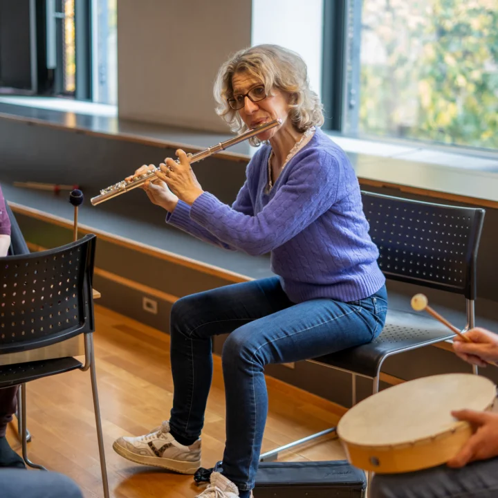 Flautist Joanna Marsh playing with Sound Sanctuary participants.