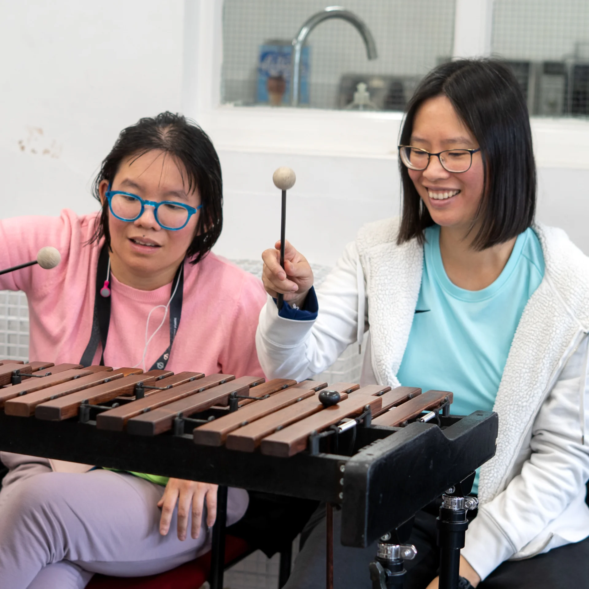 Sound Sanctuary participants playing a xylophone.
