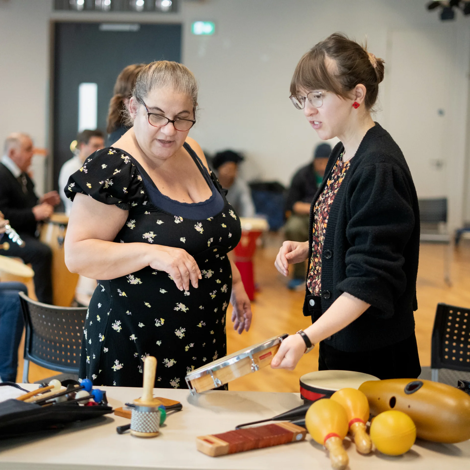 Participant and RPO Resound team member discussing instruments.