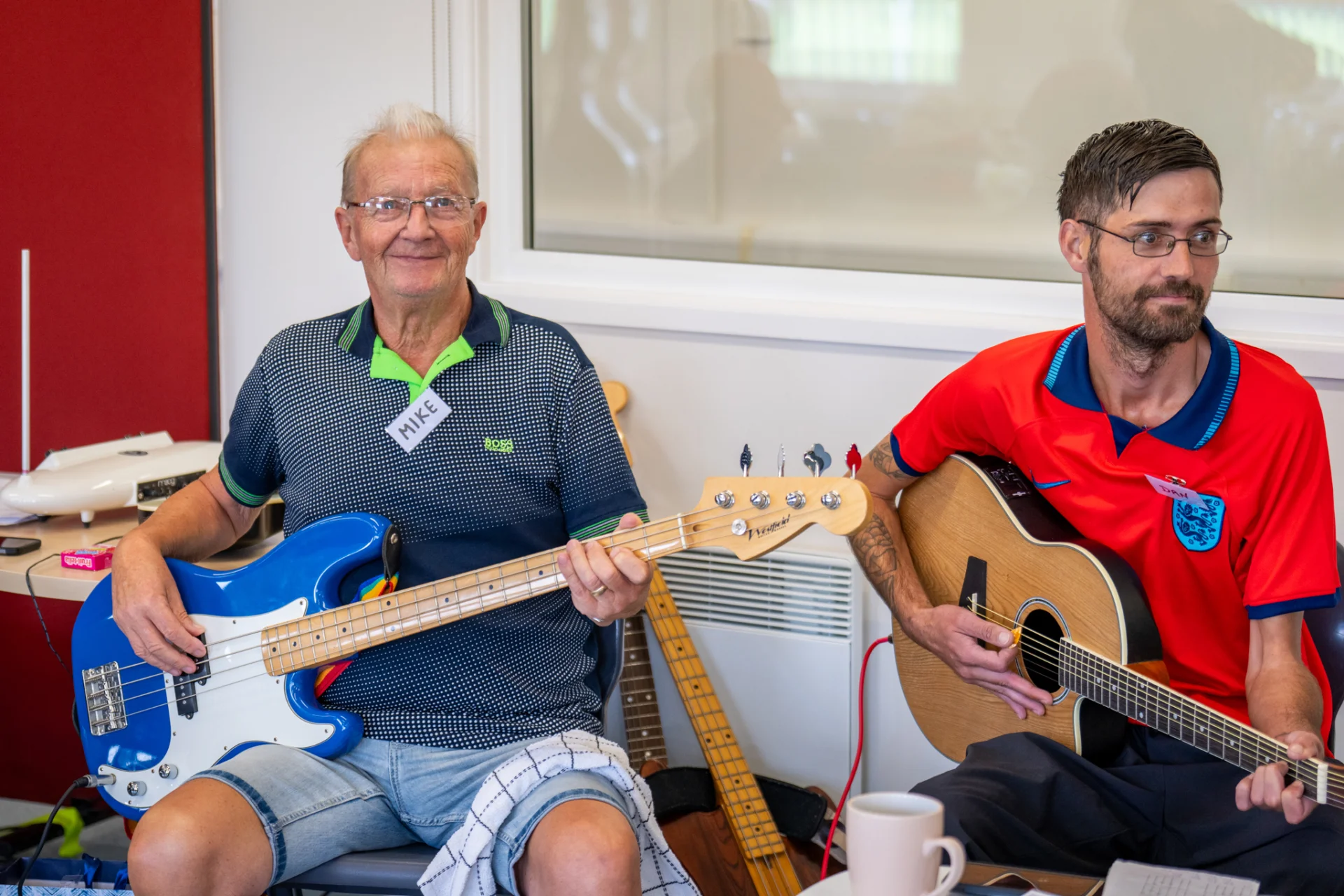 Two men play guitars
