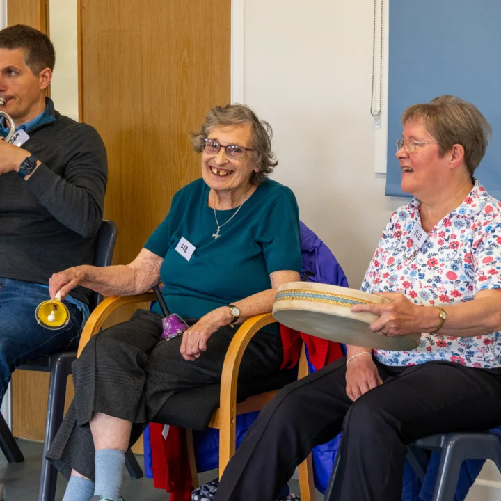 STROKESTRA Participants playing instruments during a workshop.