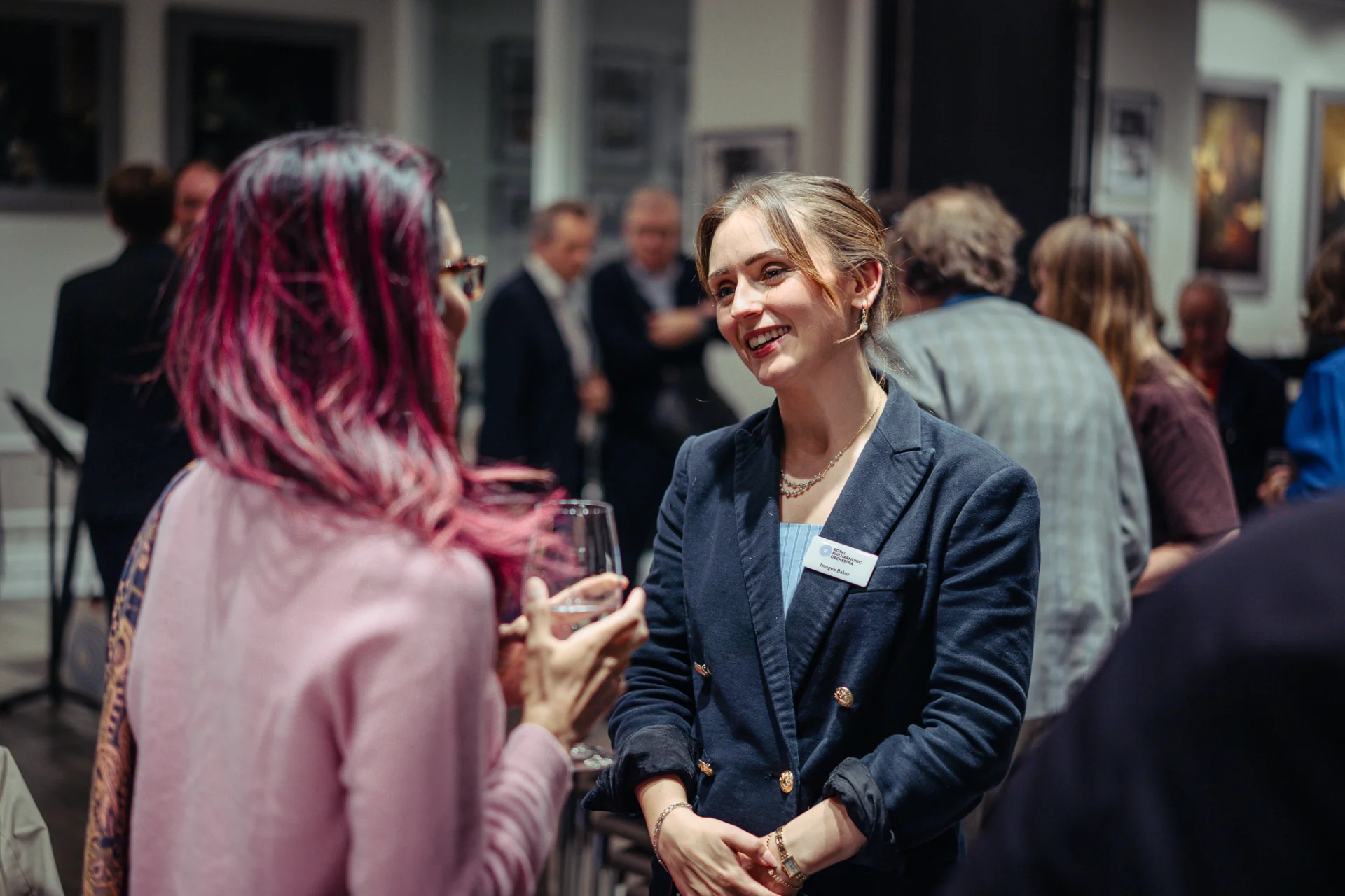 A member of the RPO's Development team in conversation at a supporters' event held at Steinway Hall.