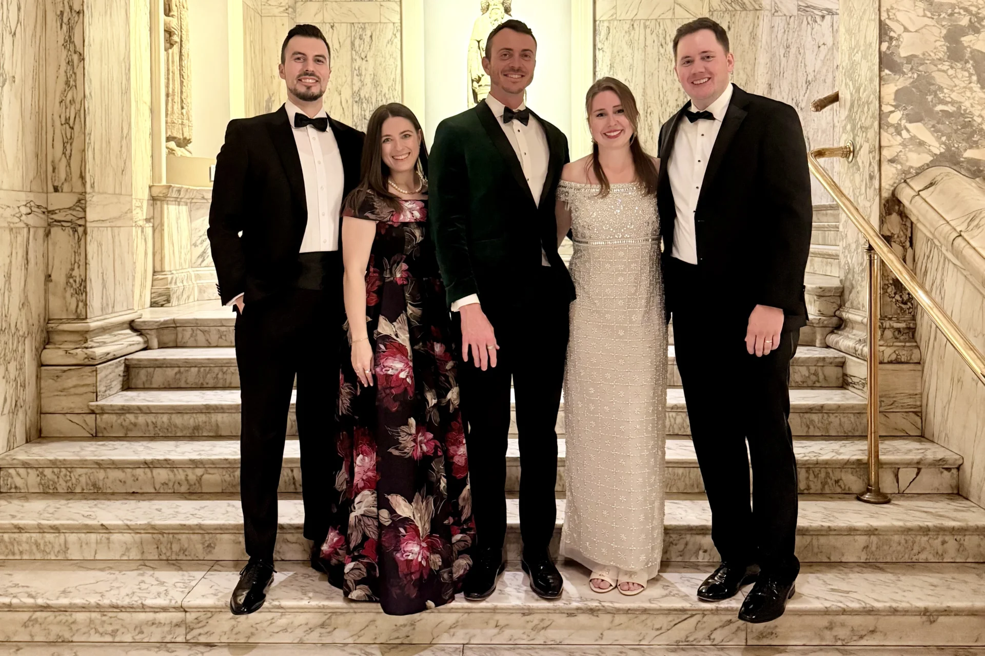 Members of the AFRPO standing on marble steps at the V&A during the RPO's 80th Anniversary Gala Evening
