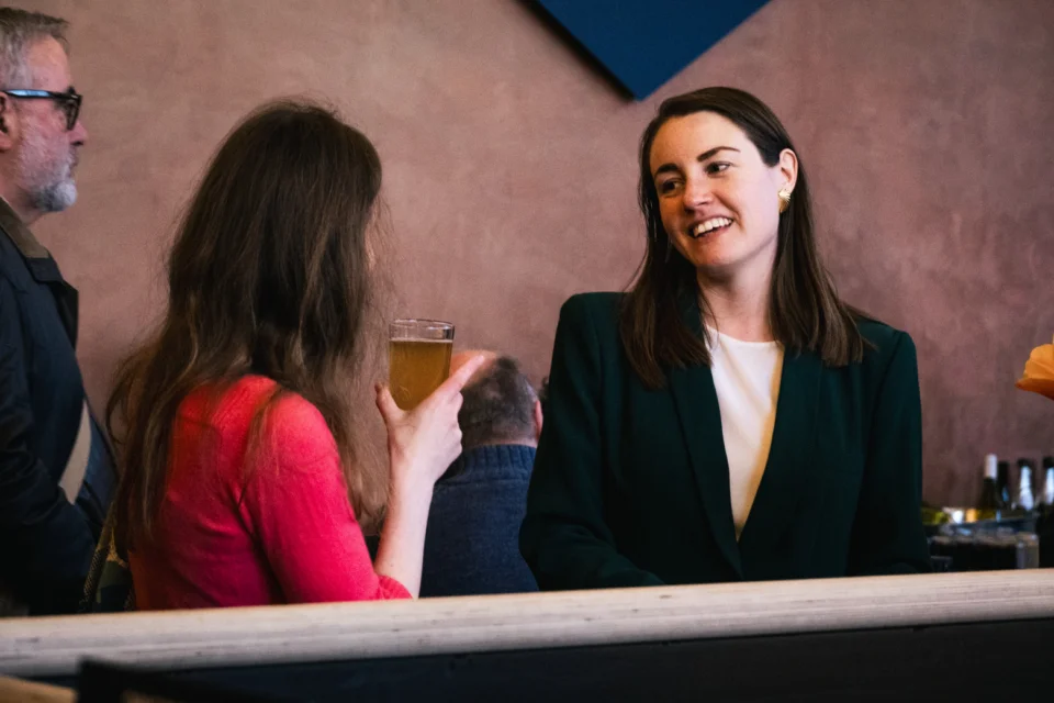 Two RPO young patrons smiling at each other during an Insights event.
