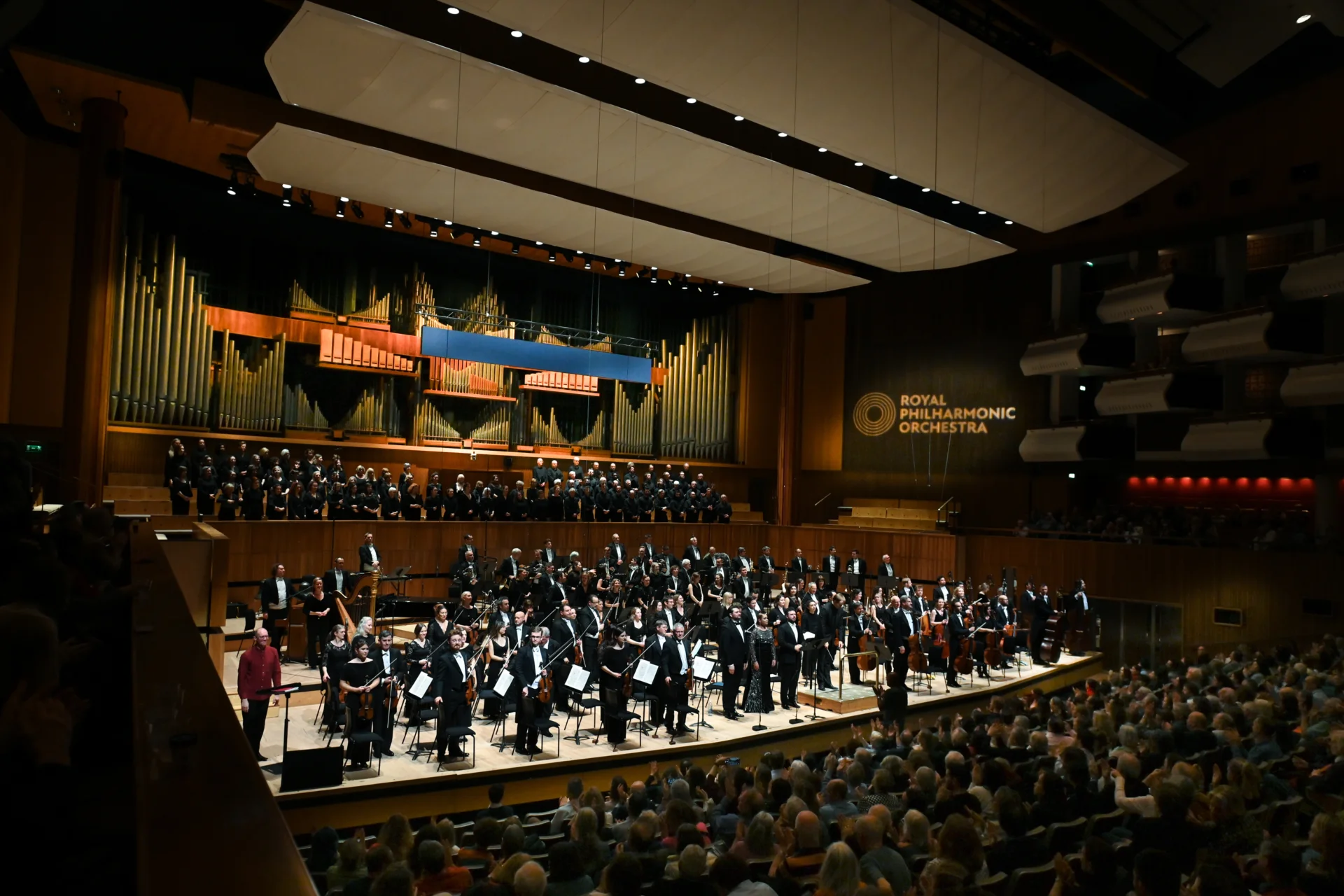 The RPO, Vasily Petrenko, soprano Mirjam Mesak, tenor Pavel Petrov, baritone Andrii Kymach and the Philharmonia Chorus standing on stage at the Royal Festival Hall to receive applause