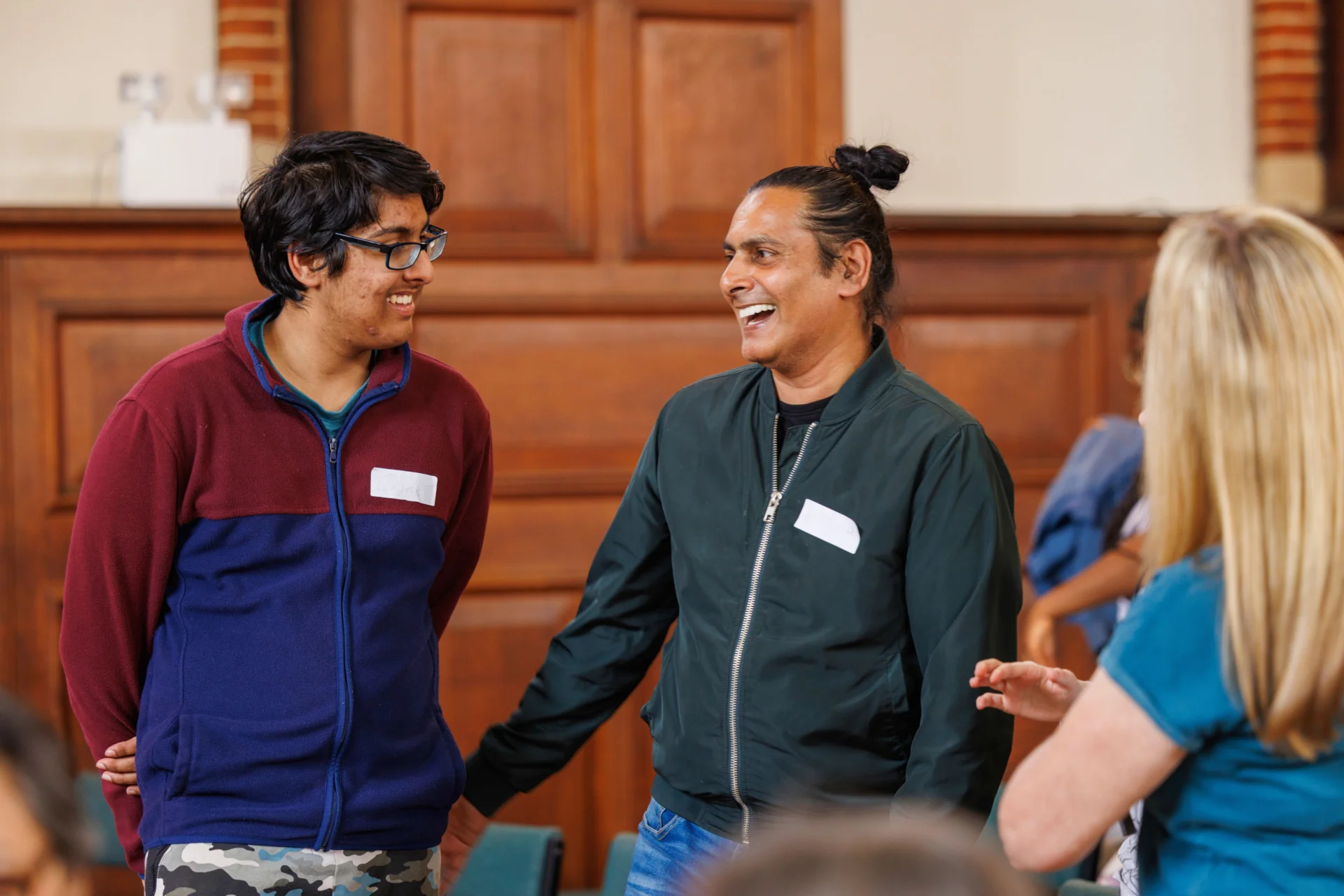 Participants in a Resound workshop play instruments together, smiling