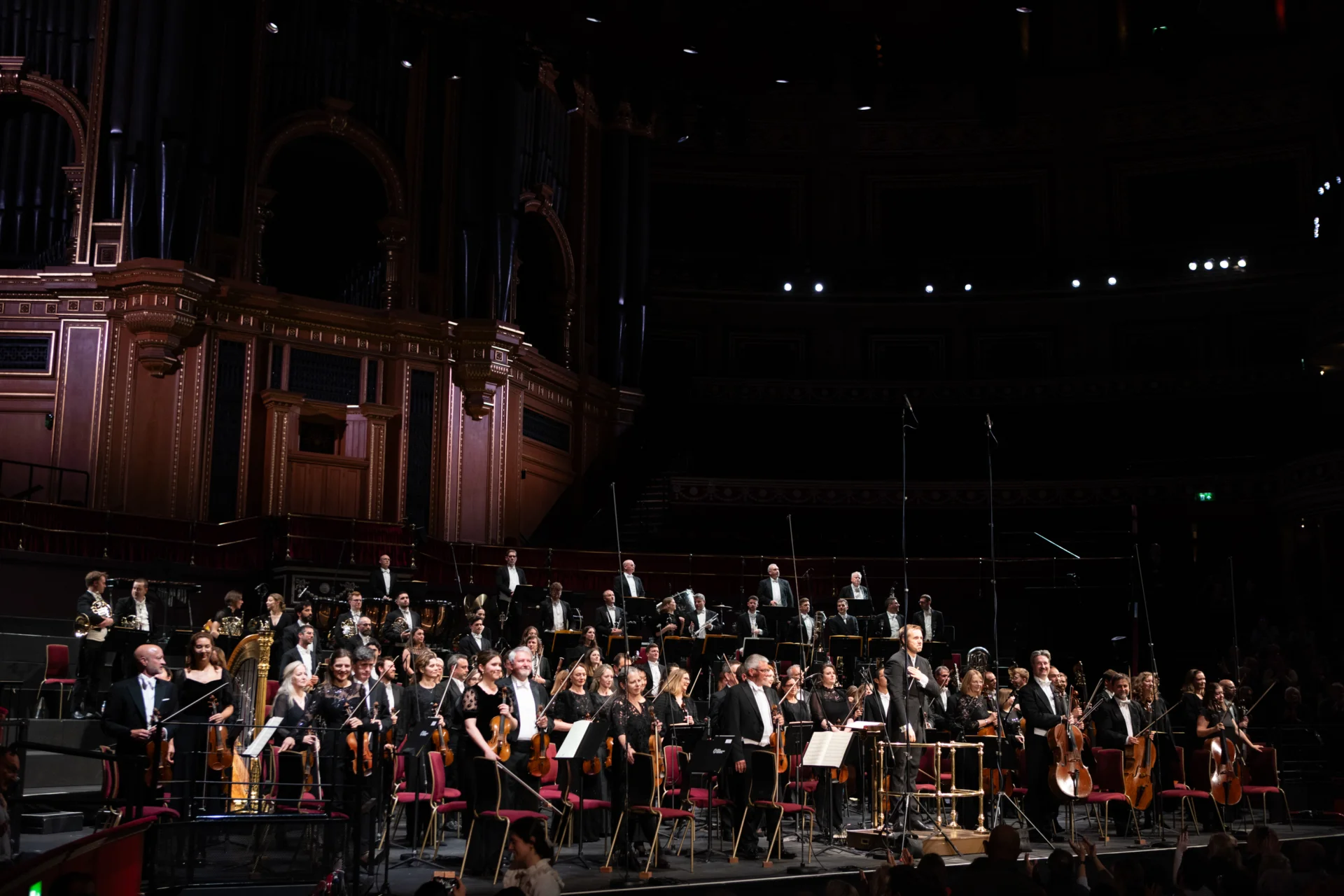 The Orchestra standing to receive applause
