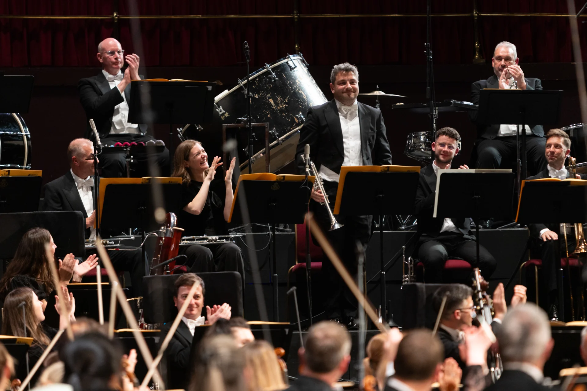 Principal Trumpet Matthew Williams standing for applause from the audience and the players