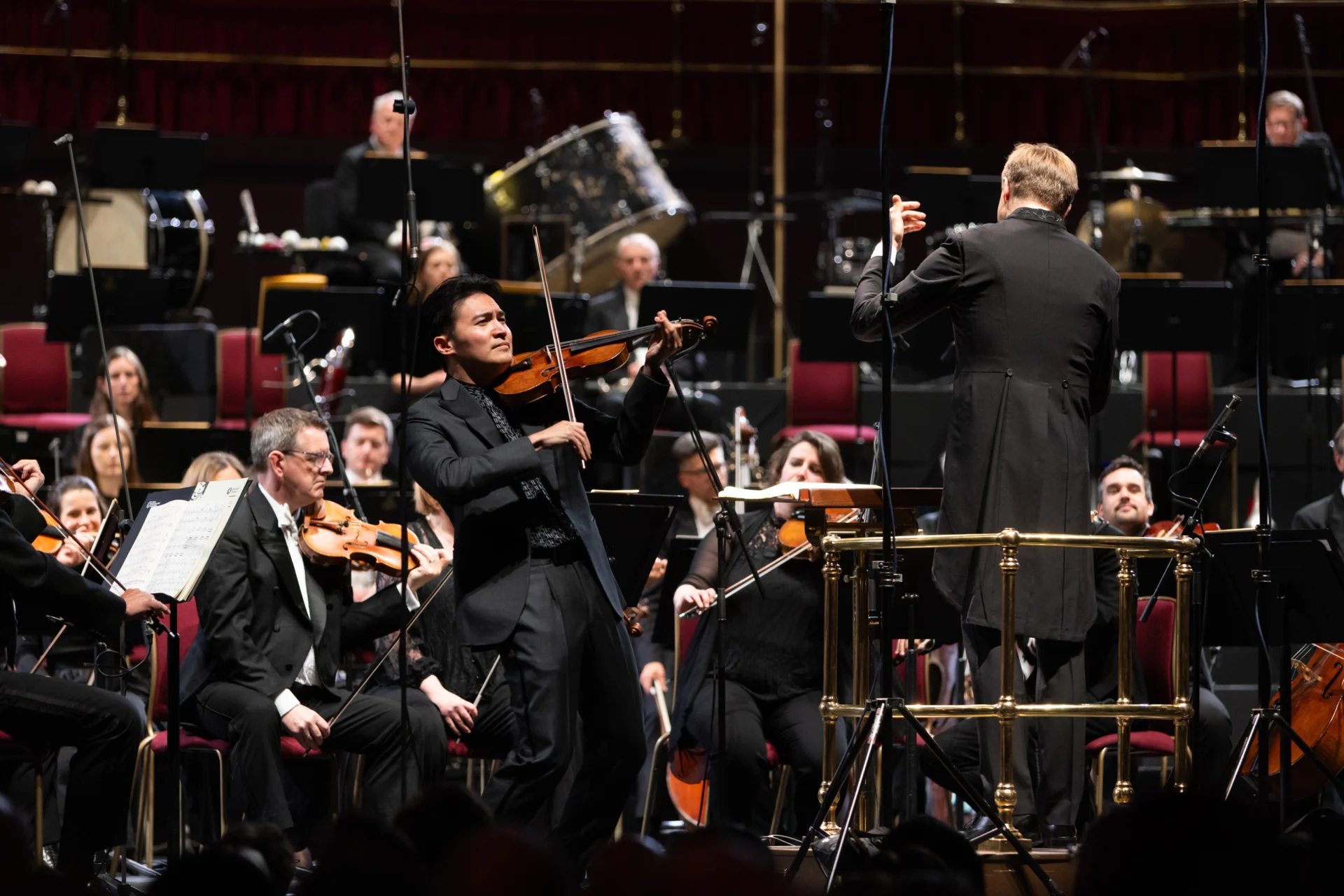 Ray Chen playing on stage in front of the Orchestra