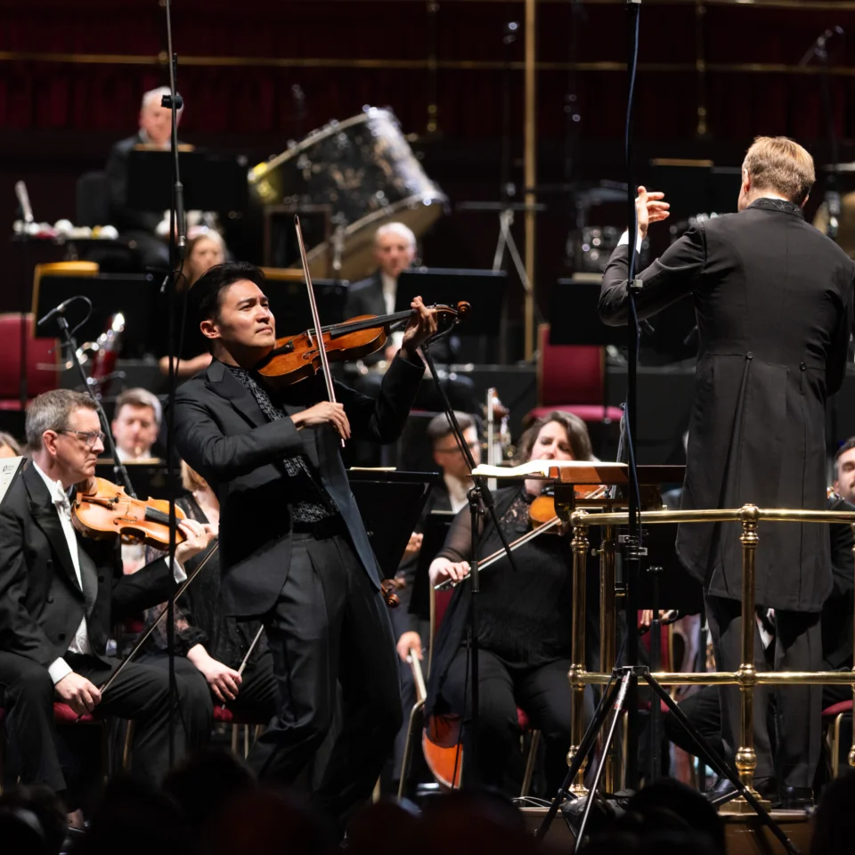 Ray Chen playing on stage in front of the Orchestra