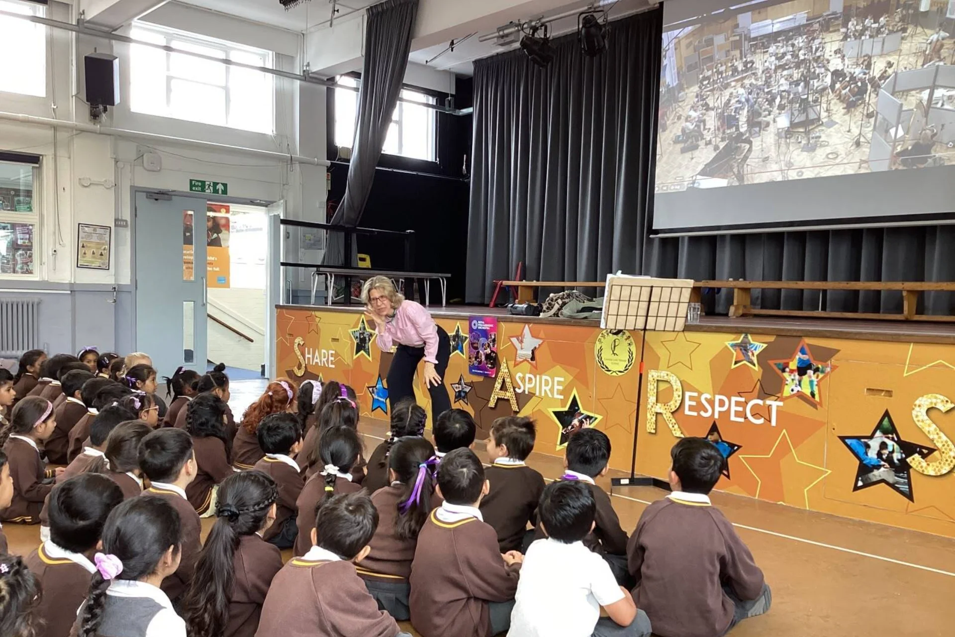 Joanna Marsh talking to students in school hall