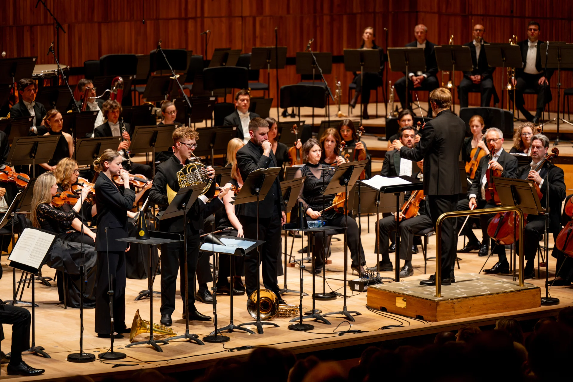 Alexander Edmundson playing the horn as Katy Woolley and Ben Hulme just play their mouthpieces