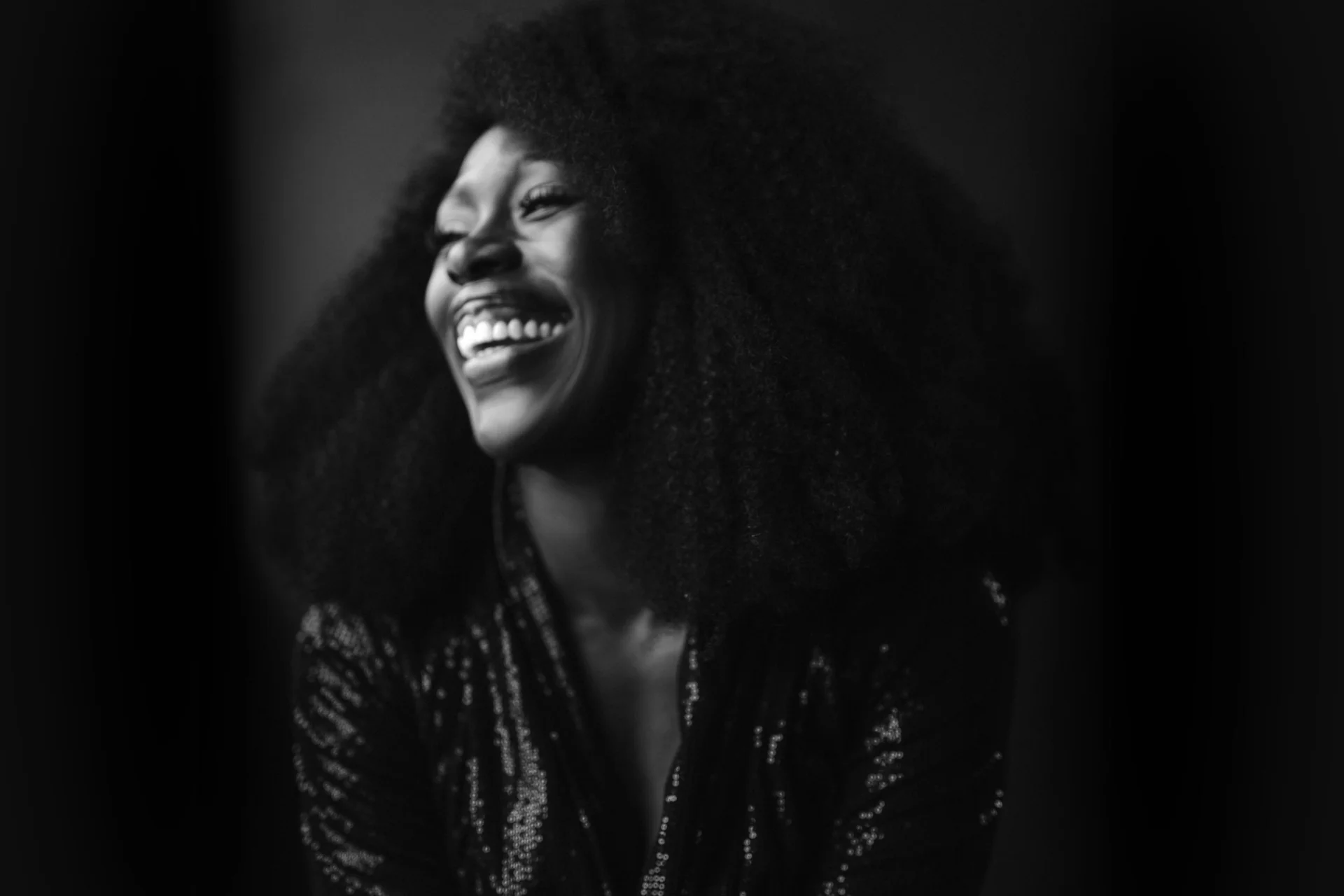 Black and white photograph of Gloria Onitiri smiling
