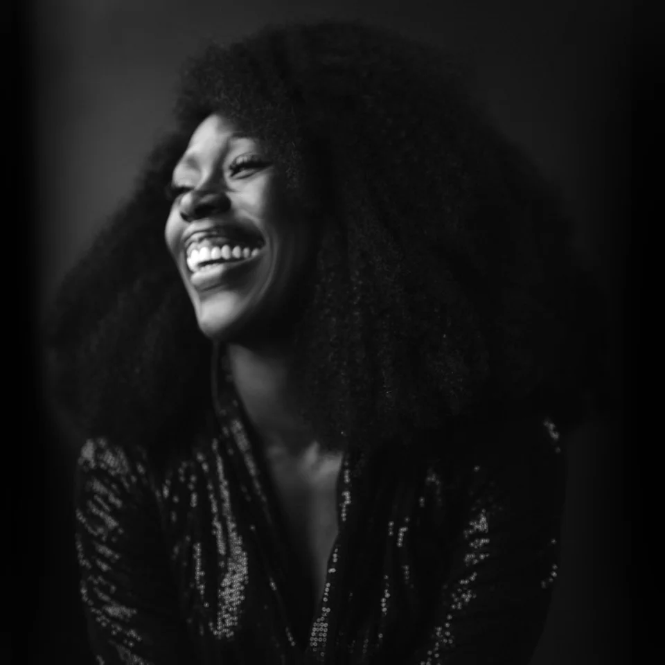 Black and white photograph of Gloria Onitiri smiling