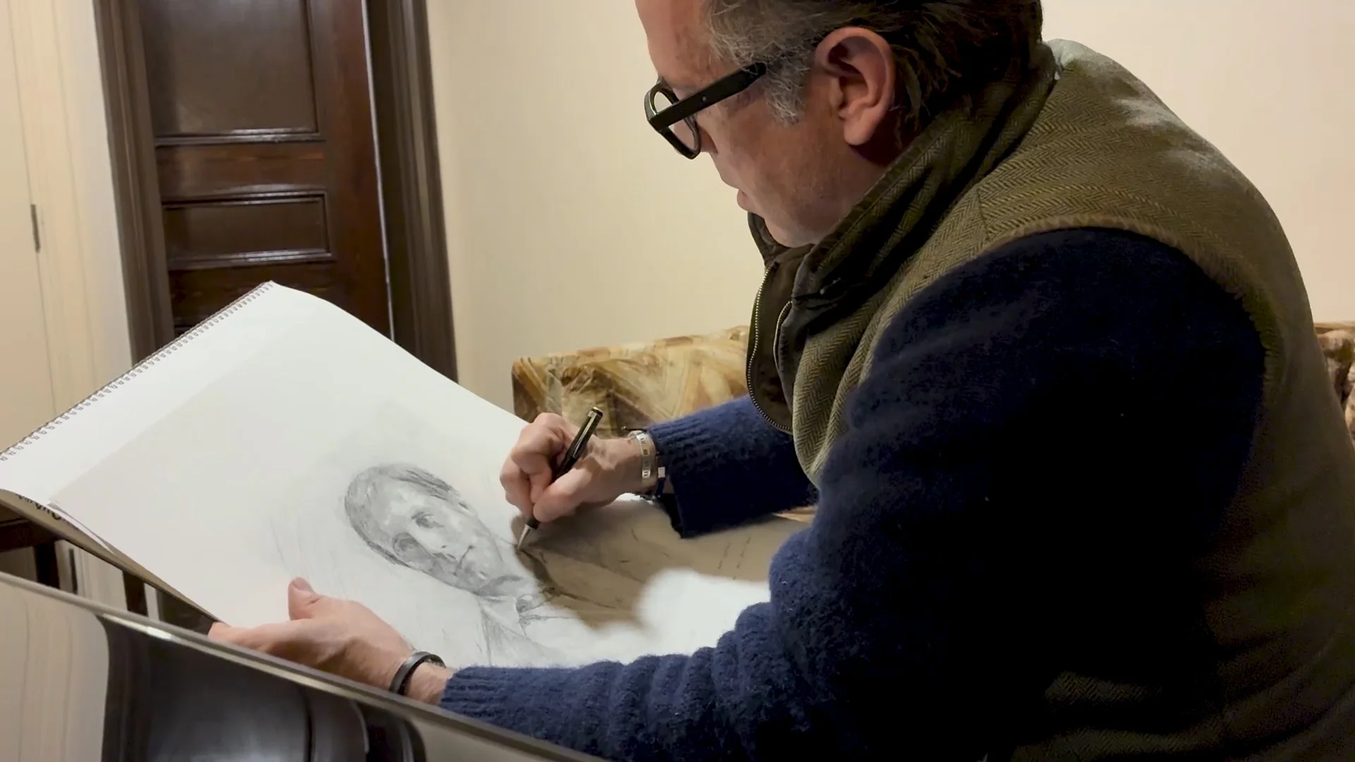 Jeremy Houghton seated and pencil sketching Vasily Petrenko