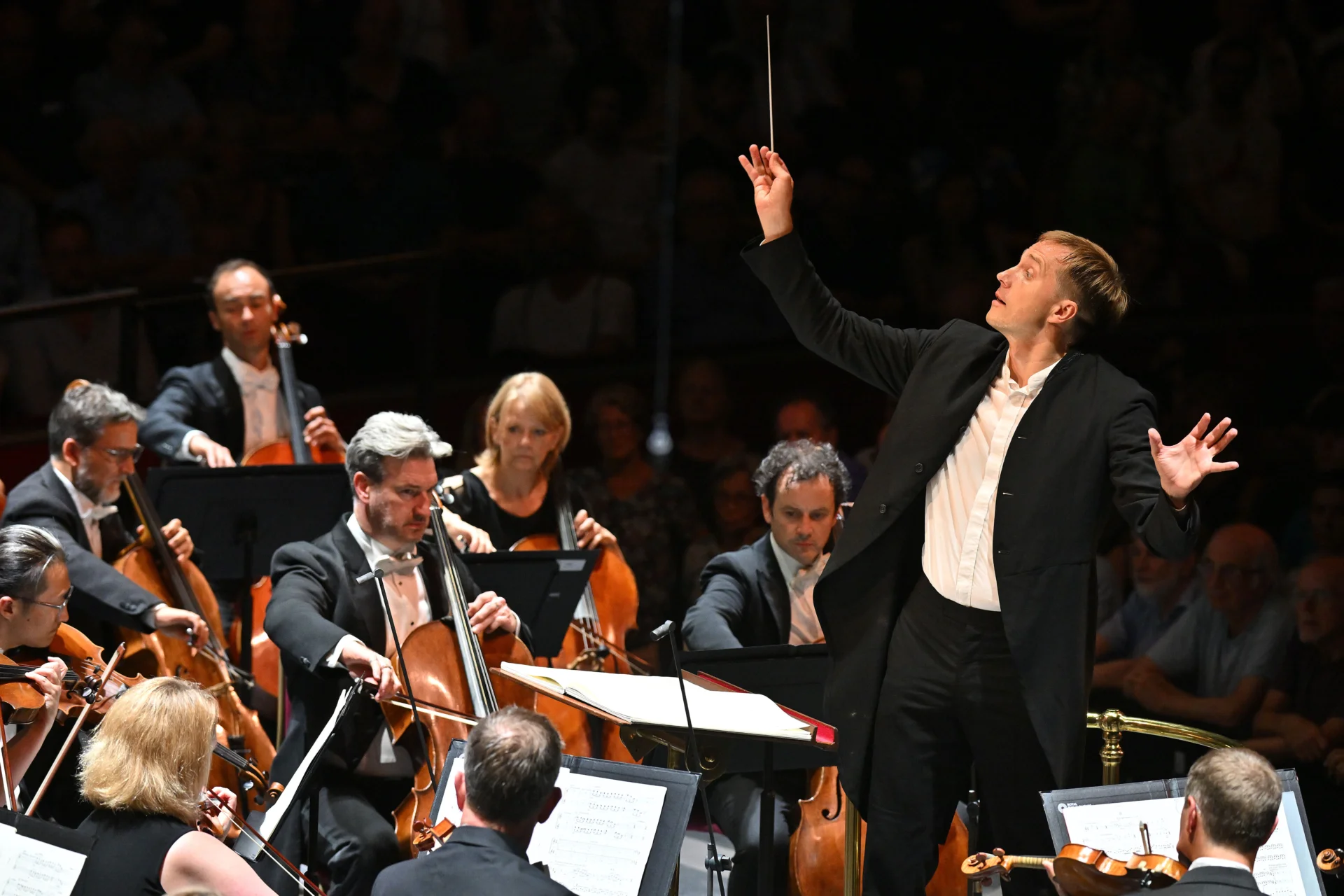 Vasily Petrenko conducting, his baton pointing upwards and his left hand spread out