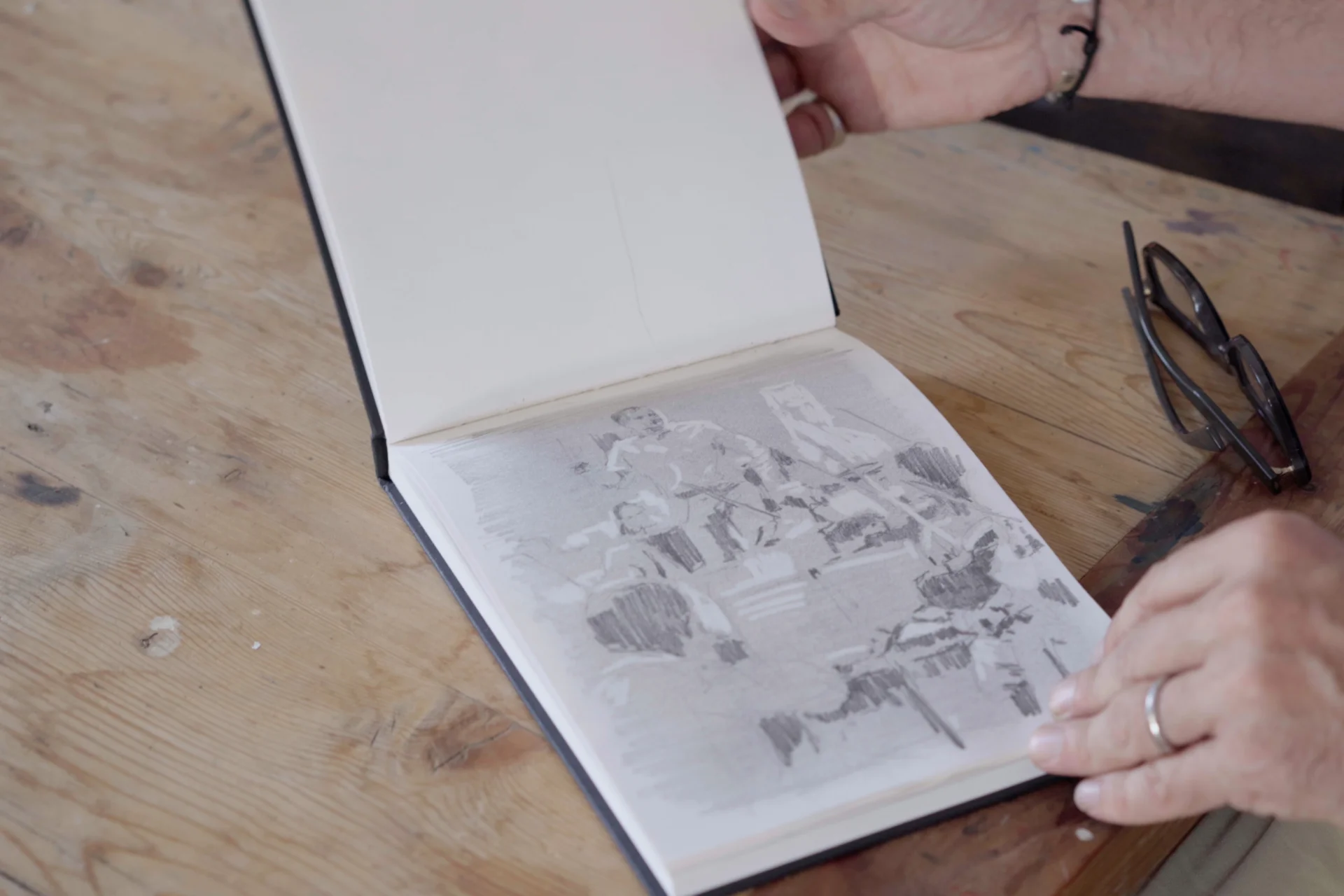 Jeremy Houghton's sketchbook open to a page with a sketch of Vasily Petrenko conducting
