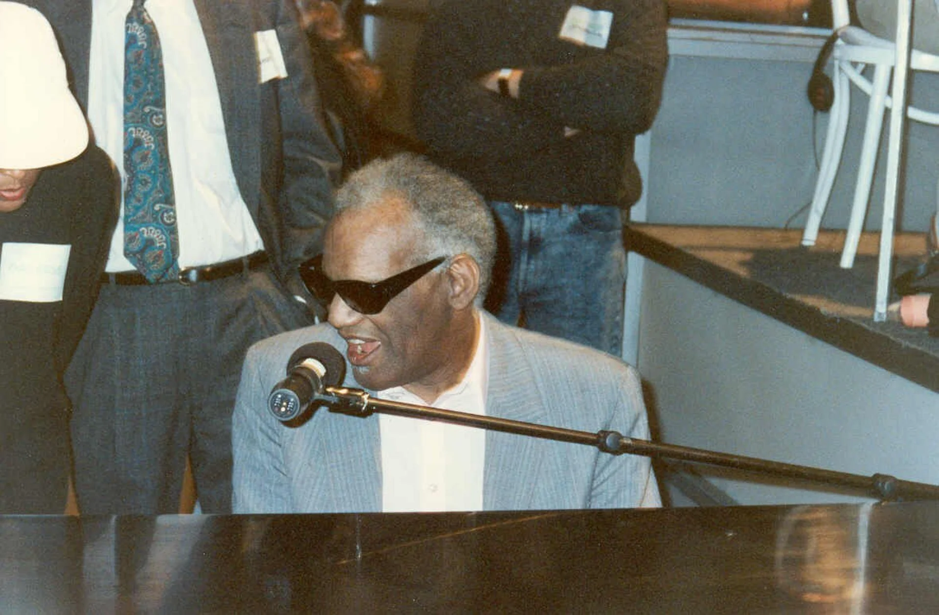 Ray Charles singing into mic at Grammy rehearsal.