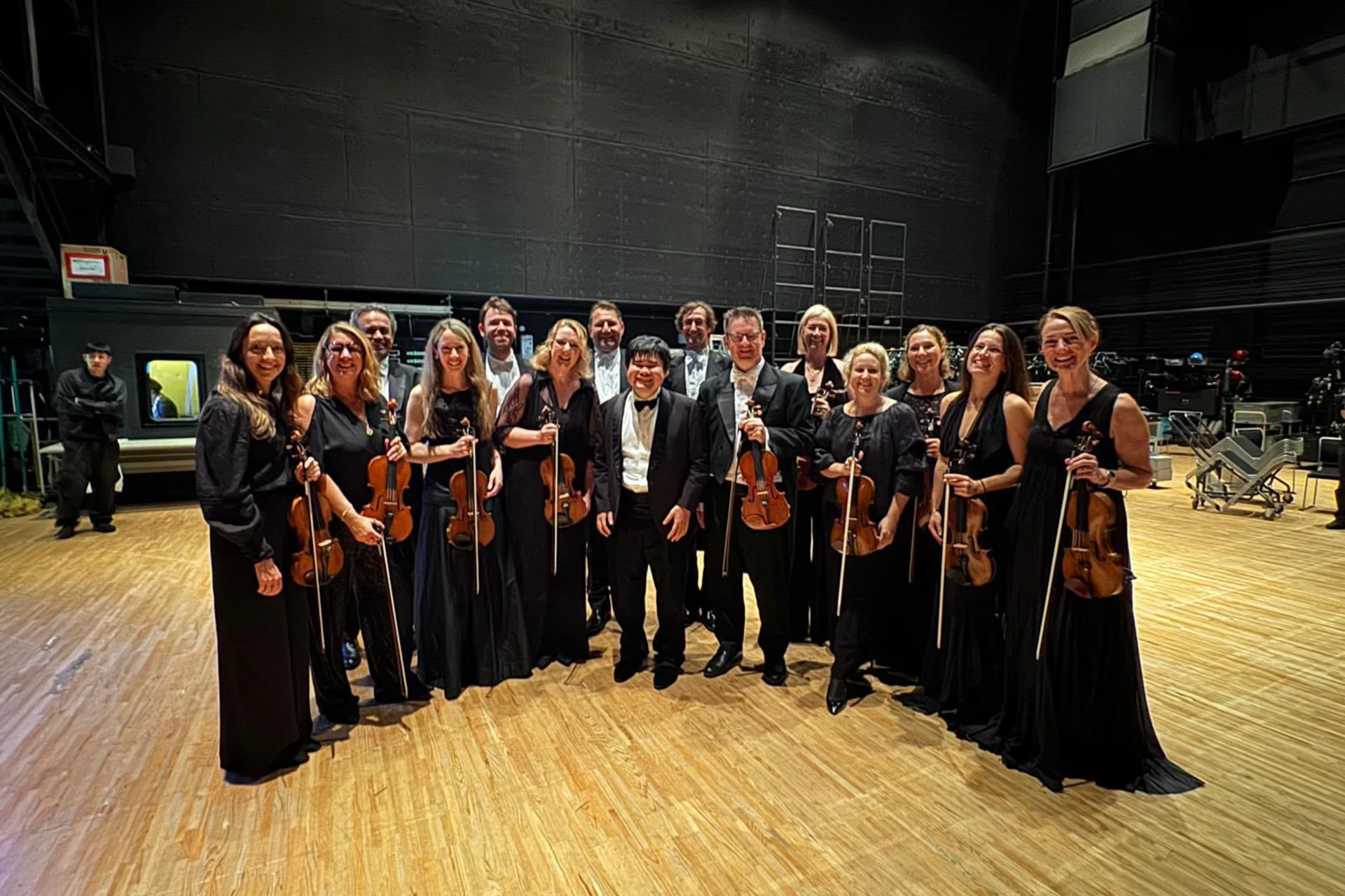 The RPO Second Violins posing with Nobuyuki Tsujii