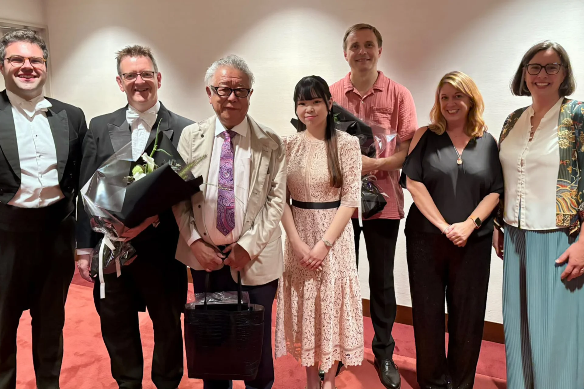 Vasily Petrenko, players and Sarah Bardwell posing with representatives from dunhill