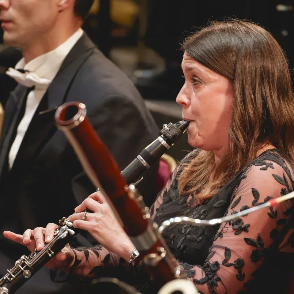 Katherine Lacy playing her clarinet in concert attire