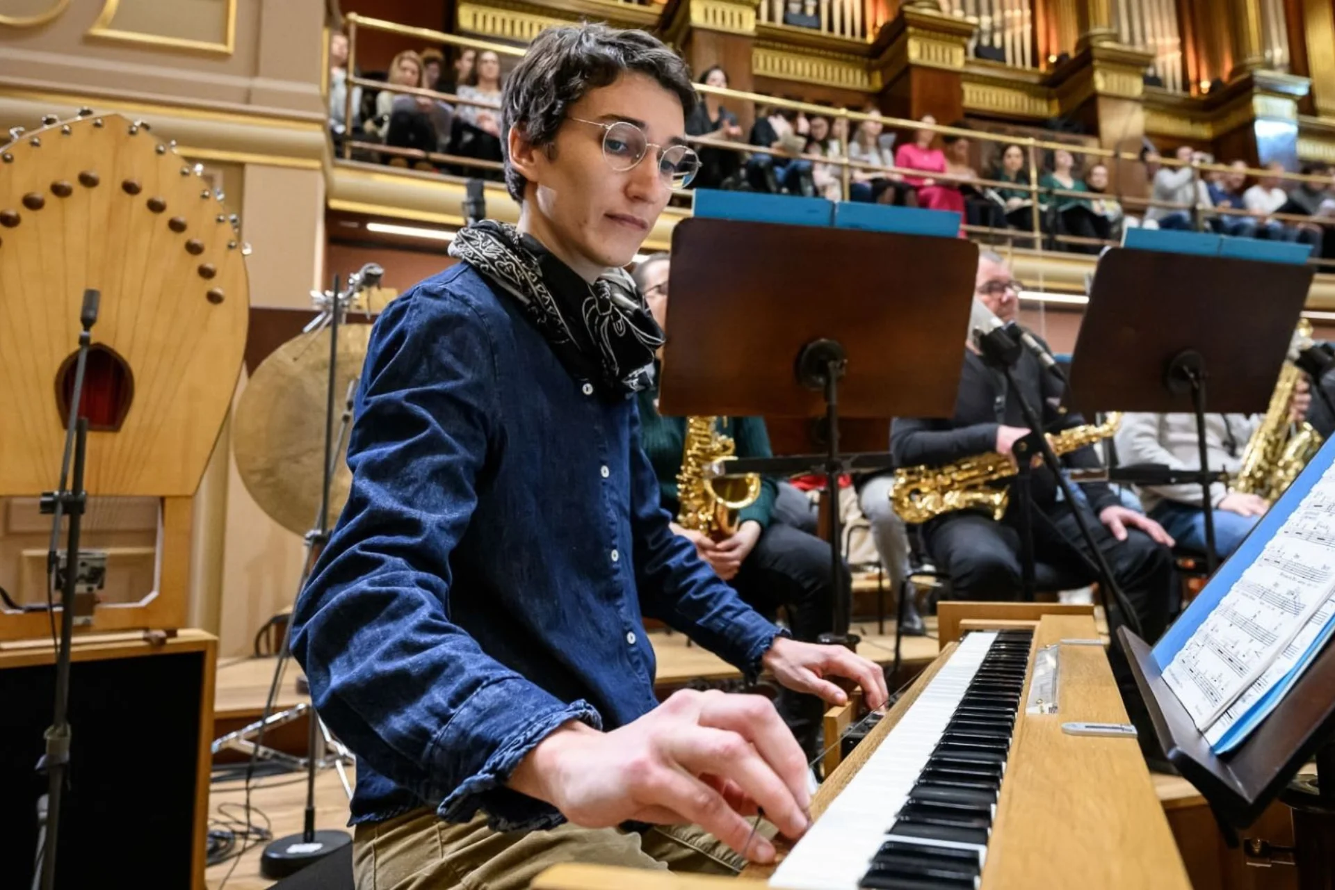 A man plays the piano as part of an orchestra