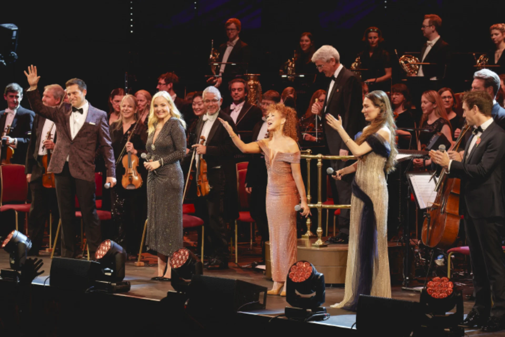 Four vocalists and presenter Bonnie Langford standind on stage at the Royal Albert Hall with the RPO to receive applause