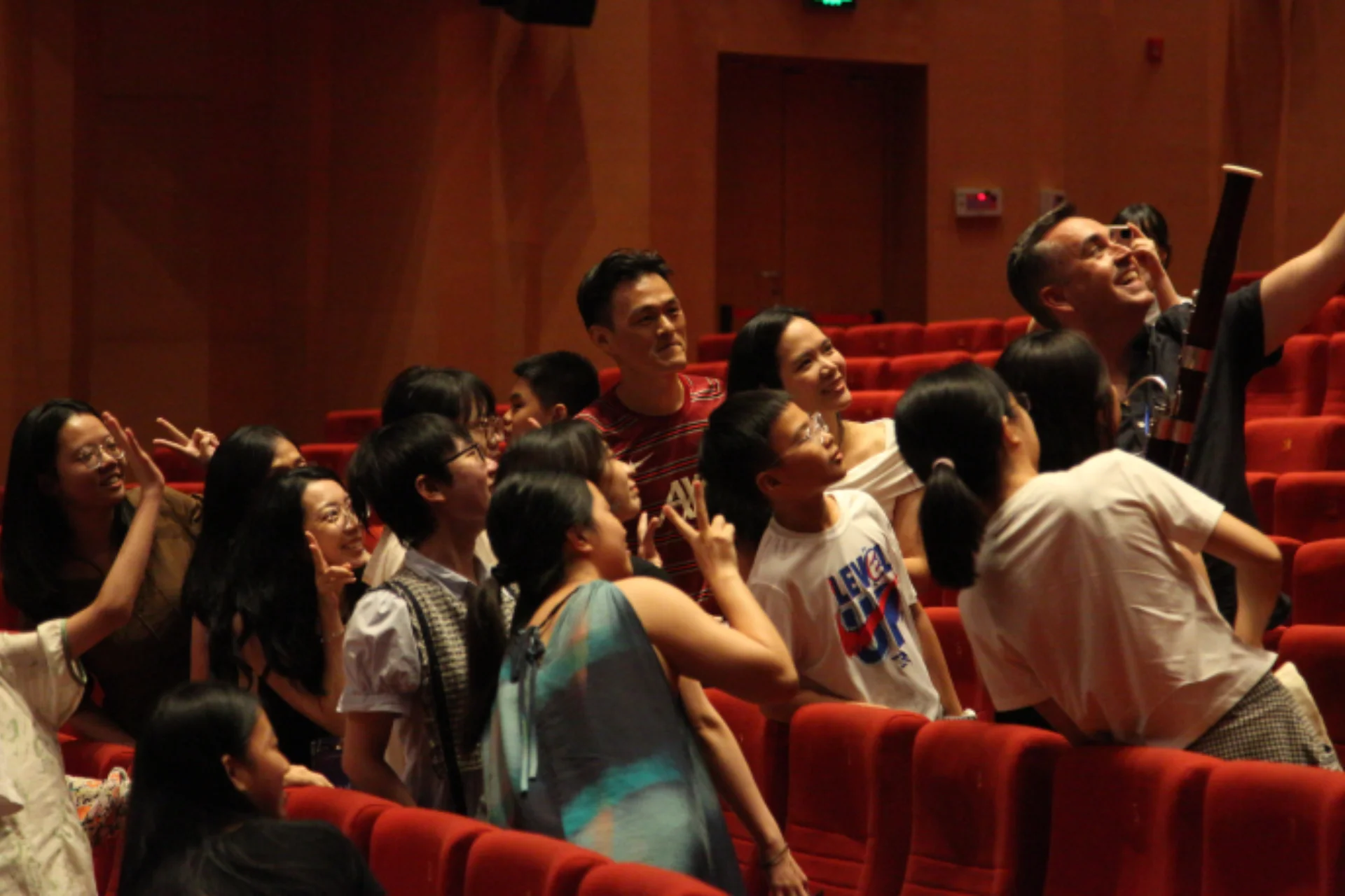 RPO Principal Contrabassoon Fraser Gordon taking a selfie with audience members and Ray Chen