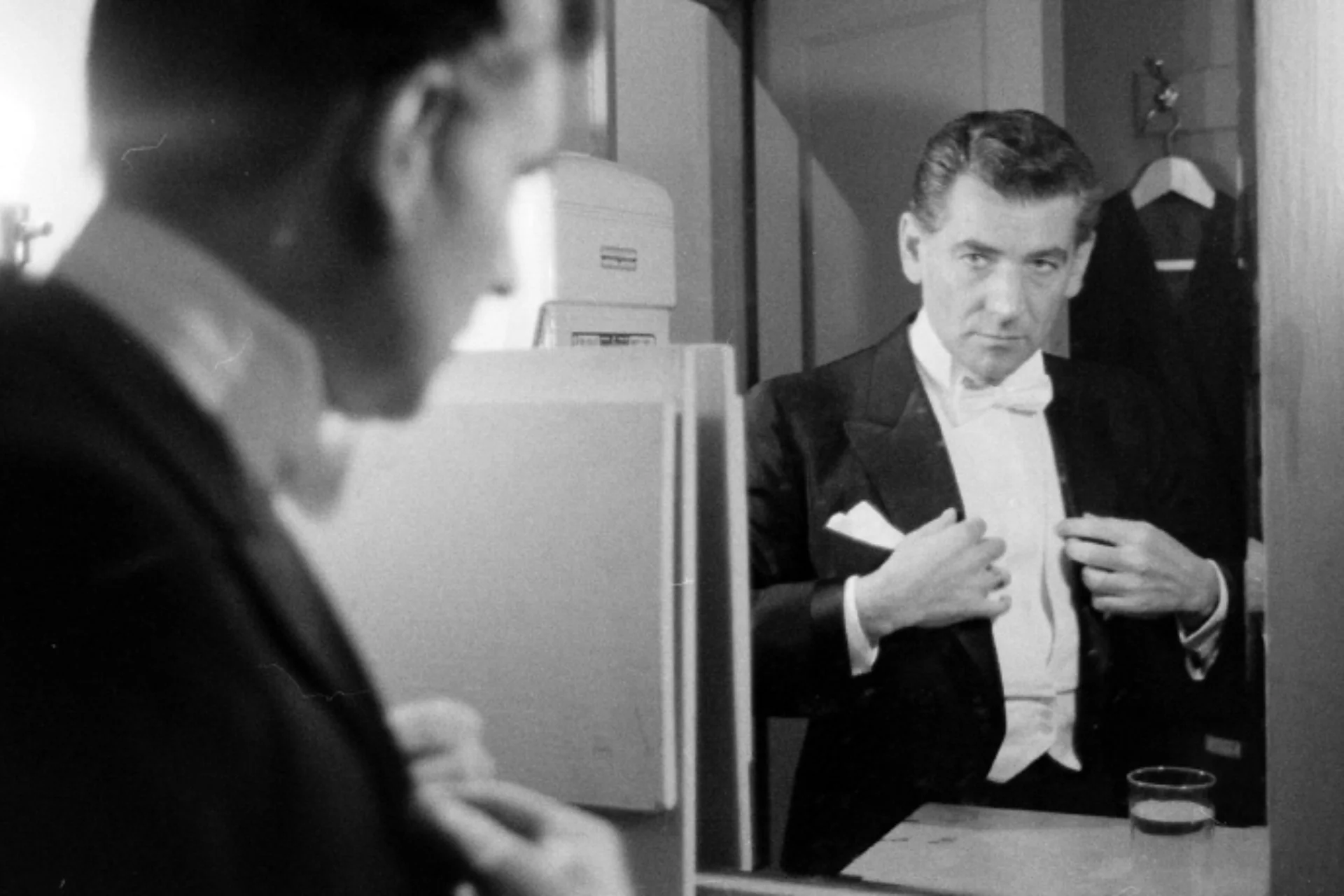 Bernstein in a tuxedo looking at himself in the mirror