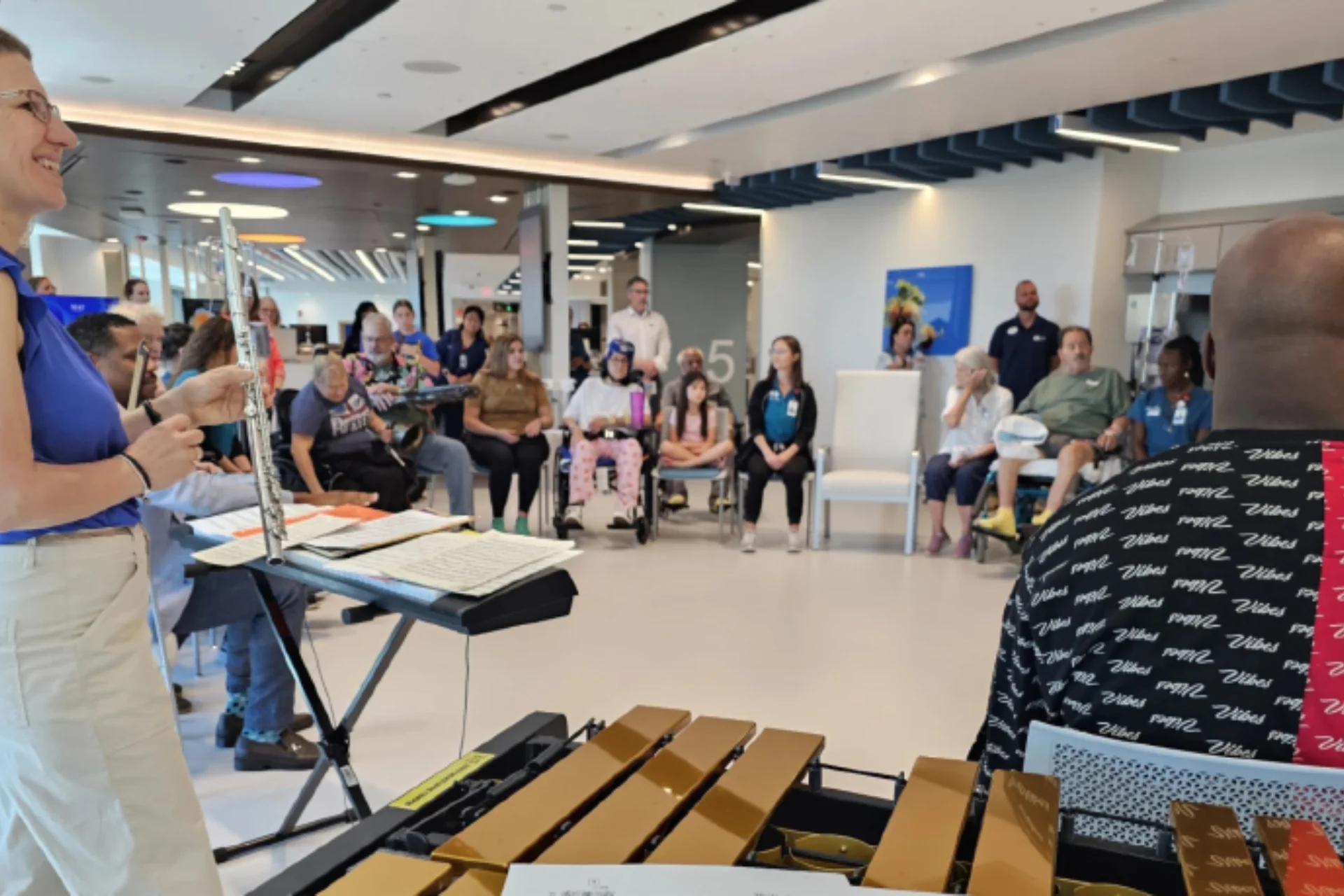 A group of adults playing music together in a circle