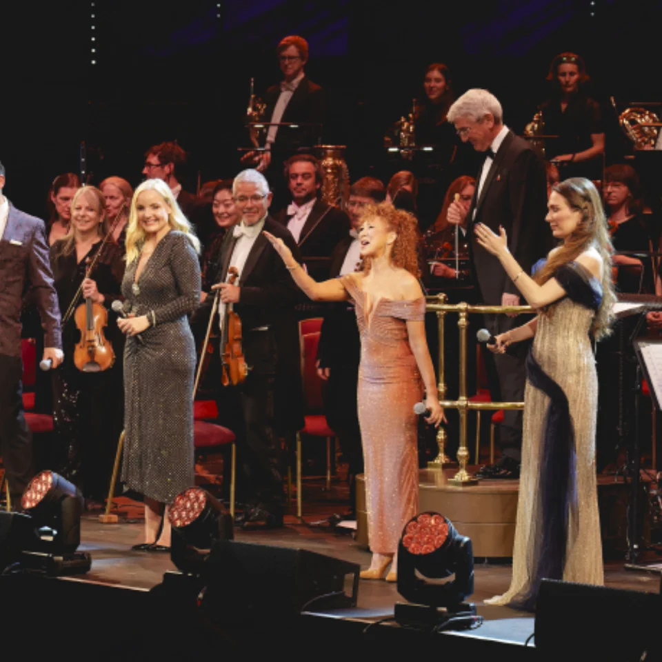 Four vocalists and presenter Bonnie Langford standind on stage at the Royal Albert Hall with the RPO to receive applause