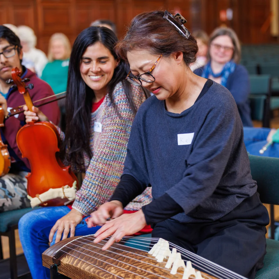 Participants in a Resound workshop play an instrument together